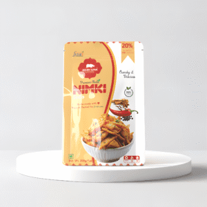 A pouch of assamese nimki in a white minimilastic background ; nimki ; assamese snack , Nimki